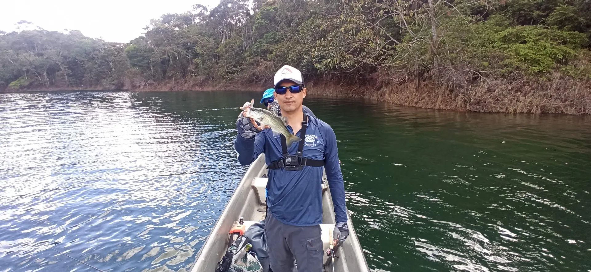 El bote navega en calma por el embalse de Jaguas al mediodía.